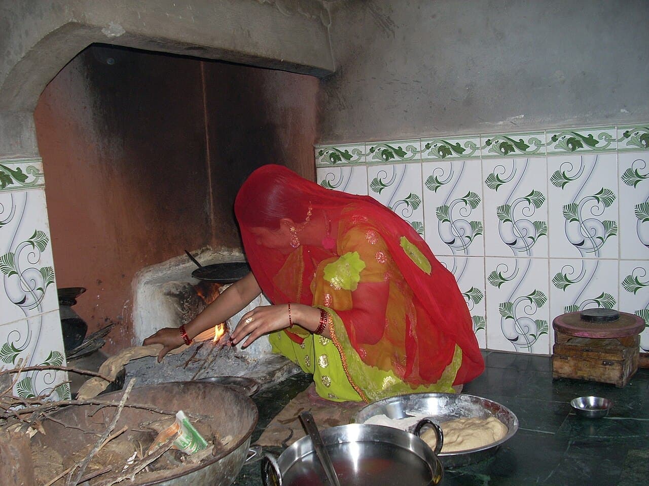 A cook working at a clay oven